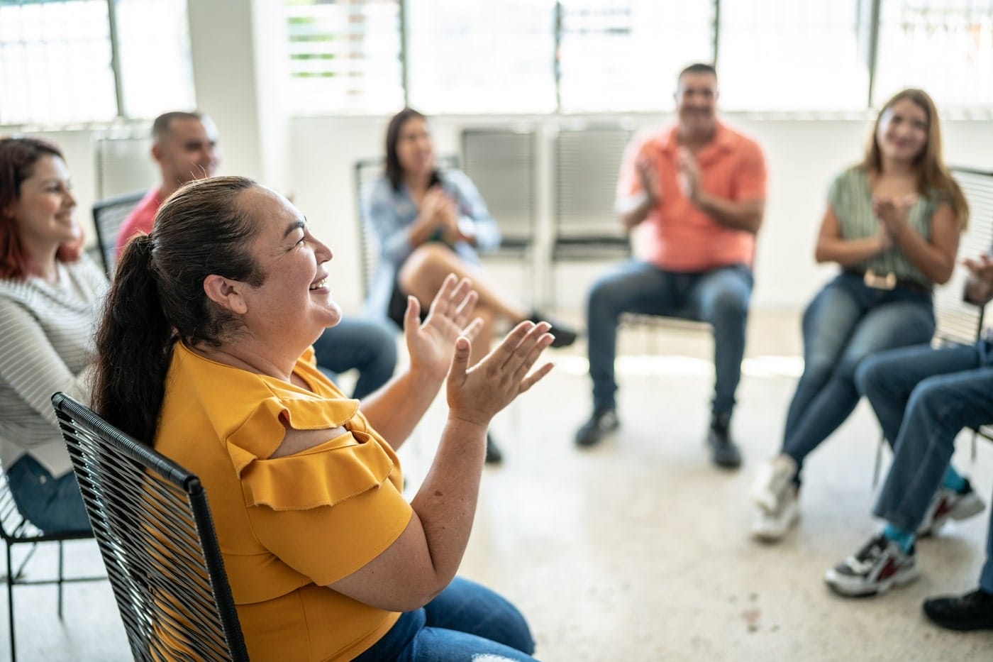 Participants clapping during focus group, celebrating inclusive dialogue, community engagement, and co-design achievements.