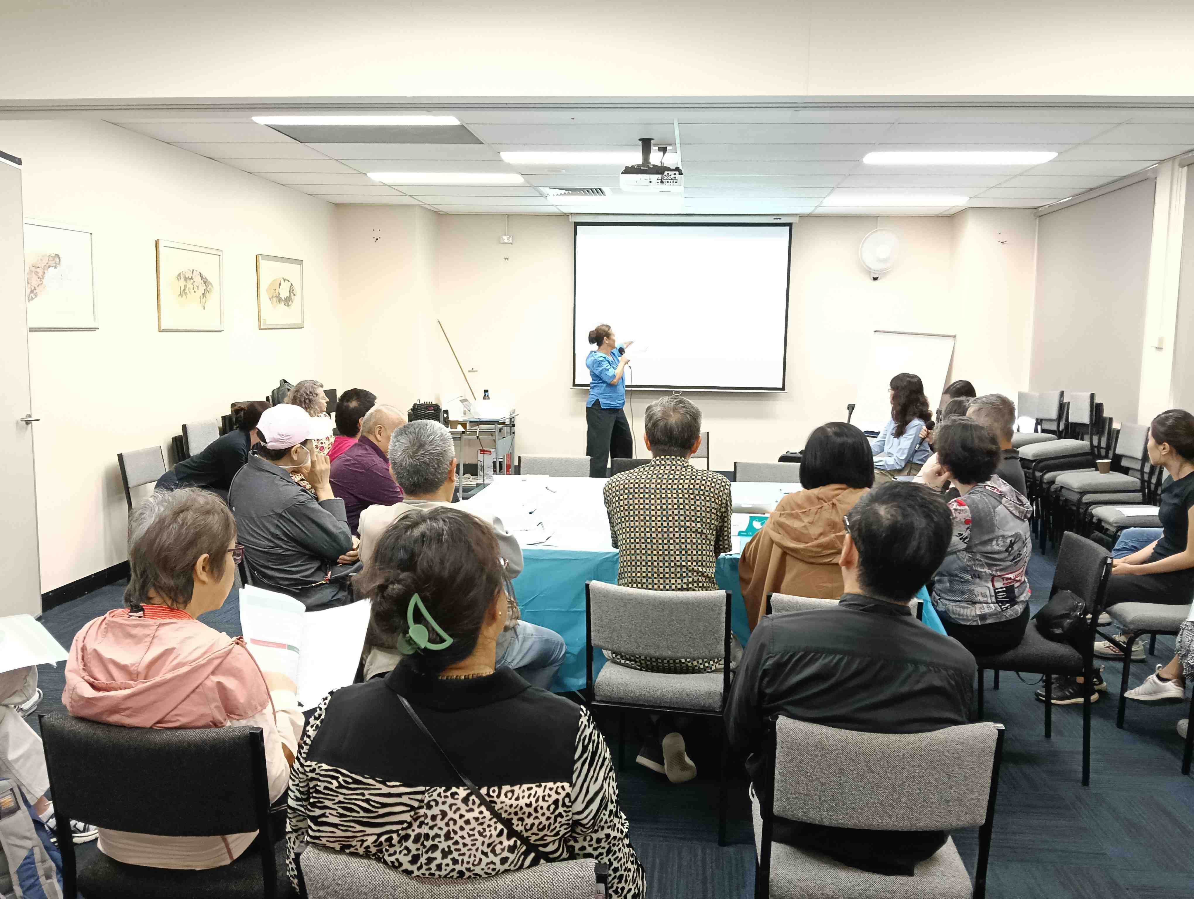 Natasha Doherty presenting to a group, facilitating discussion, collaboration, and co-design in a workshop setting.